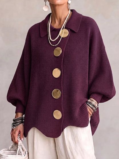 Front view of the plum purple version worn by a model, showing the oversized gold buttons, collar and wavy hem. 2