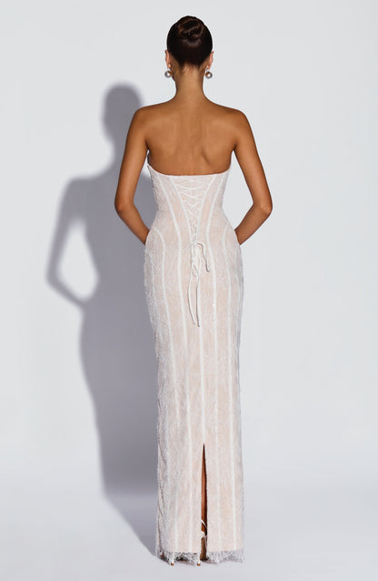 Back view of the white beaded lace dress, showing the lace-up corset back with long ties and a centre slit. 10