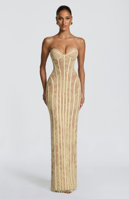 Model facing forward in a pale yellow strapless lace maxi dress with sweetheart bust, vertical corset boning and a sheer nude lining. 21