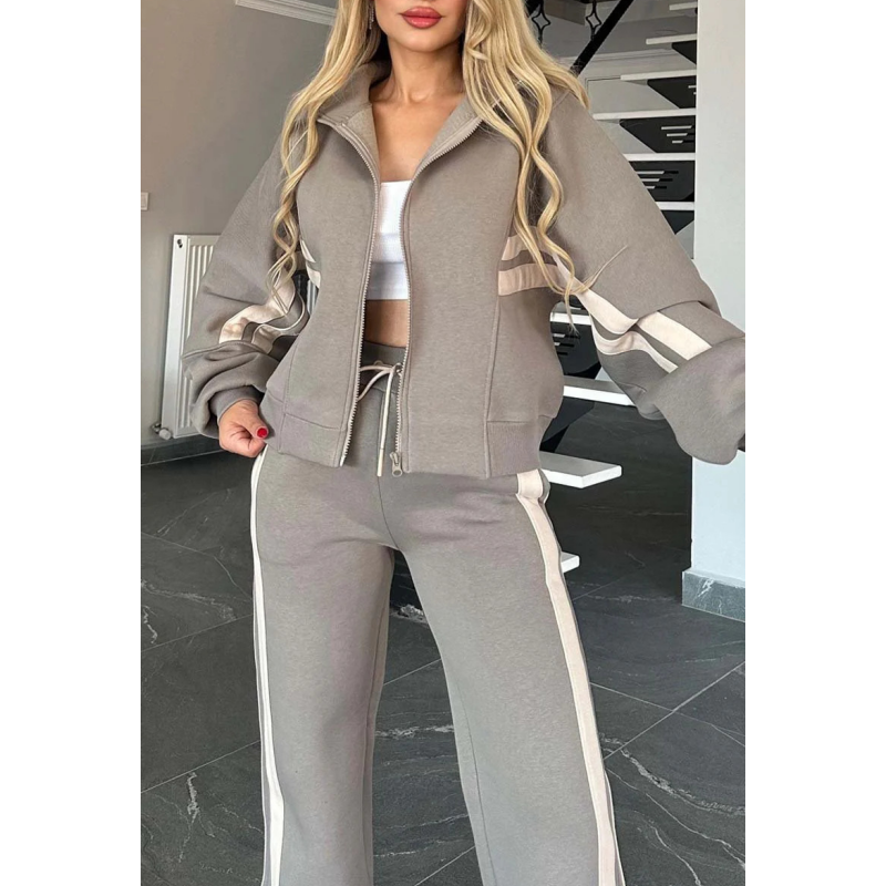 Close-up of the grey set's zip-up jacket with cream sleeve stripes, ribbed hem, pockets and drawstring waistband. 7