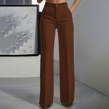 Front view of brown high-waisted straight-leg trousers with pressed centre crease, worn by a model in a grey room. 8