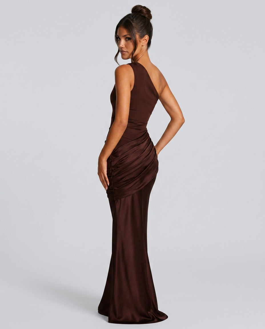 Chocolate brown dress seen from behind, showing the open back, gathered ruching at the hip and flared fishtail hem. 7