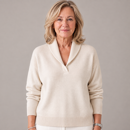 Woman standing with arms by her sides in the jumper in cream, shawl collar and ribbed cuffs visible. 2