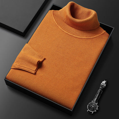 Folded burnt orange roll-neck jumper with ribbed collar and cuff in a black box, beside a wristwatch. 8
